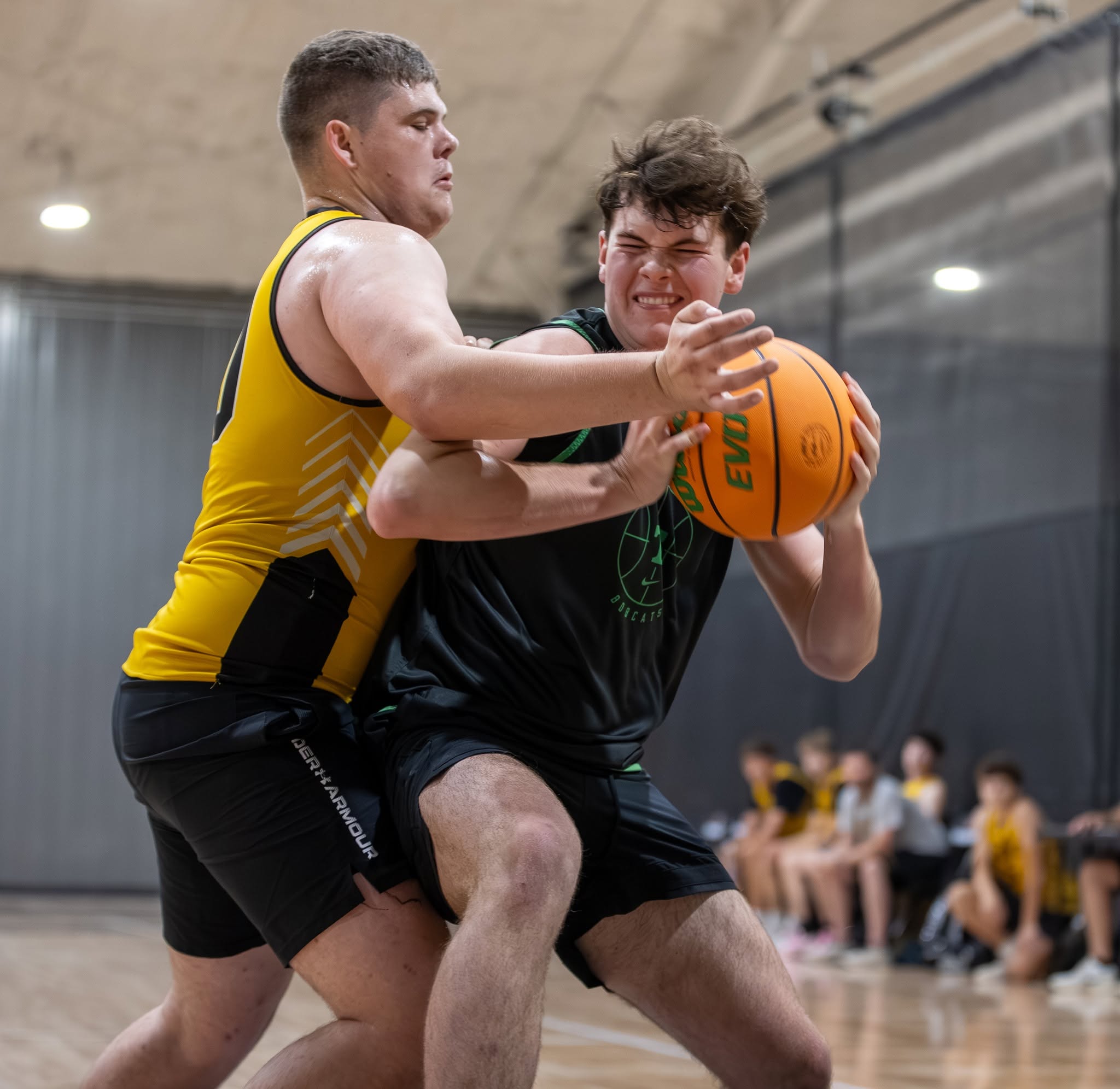 Two basketball players competing at The Hardwoods