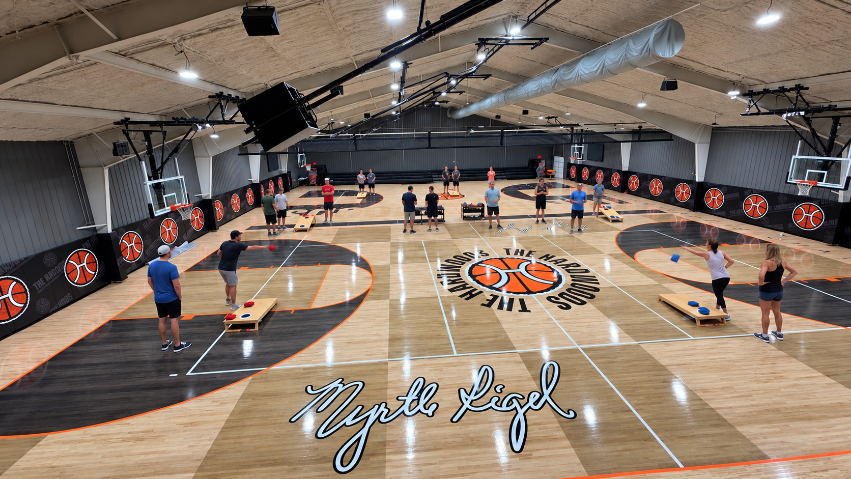 Players competing in a cornhole league at The Hardwoods