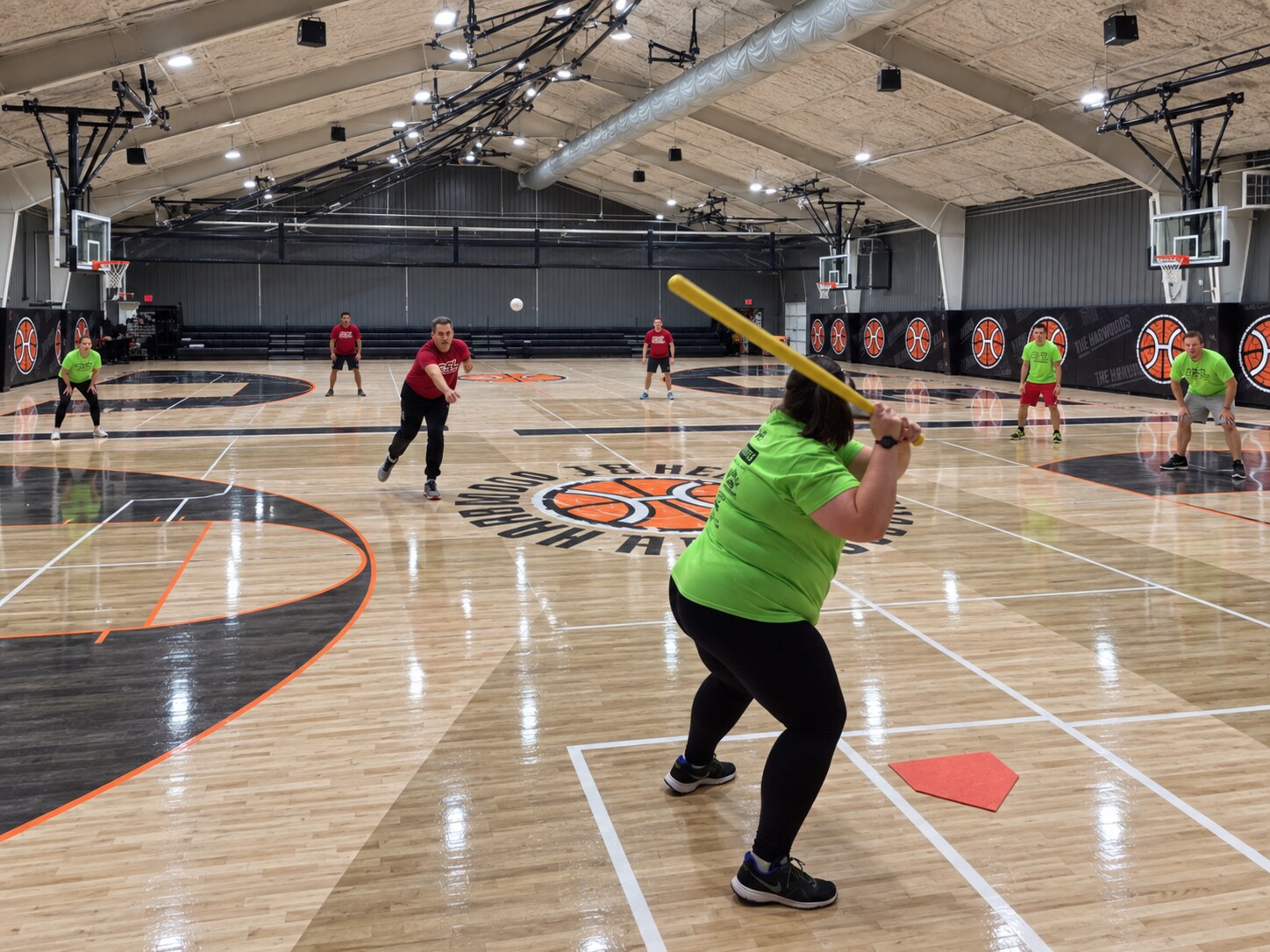 Players competing in a Wiffle ball league at The Hardwoods